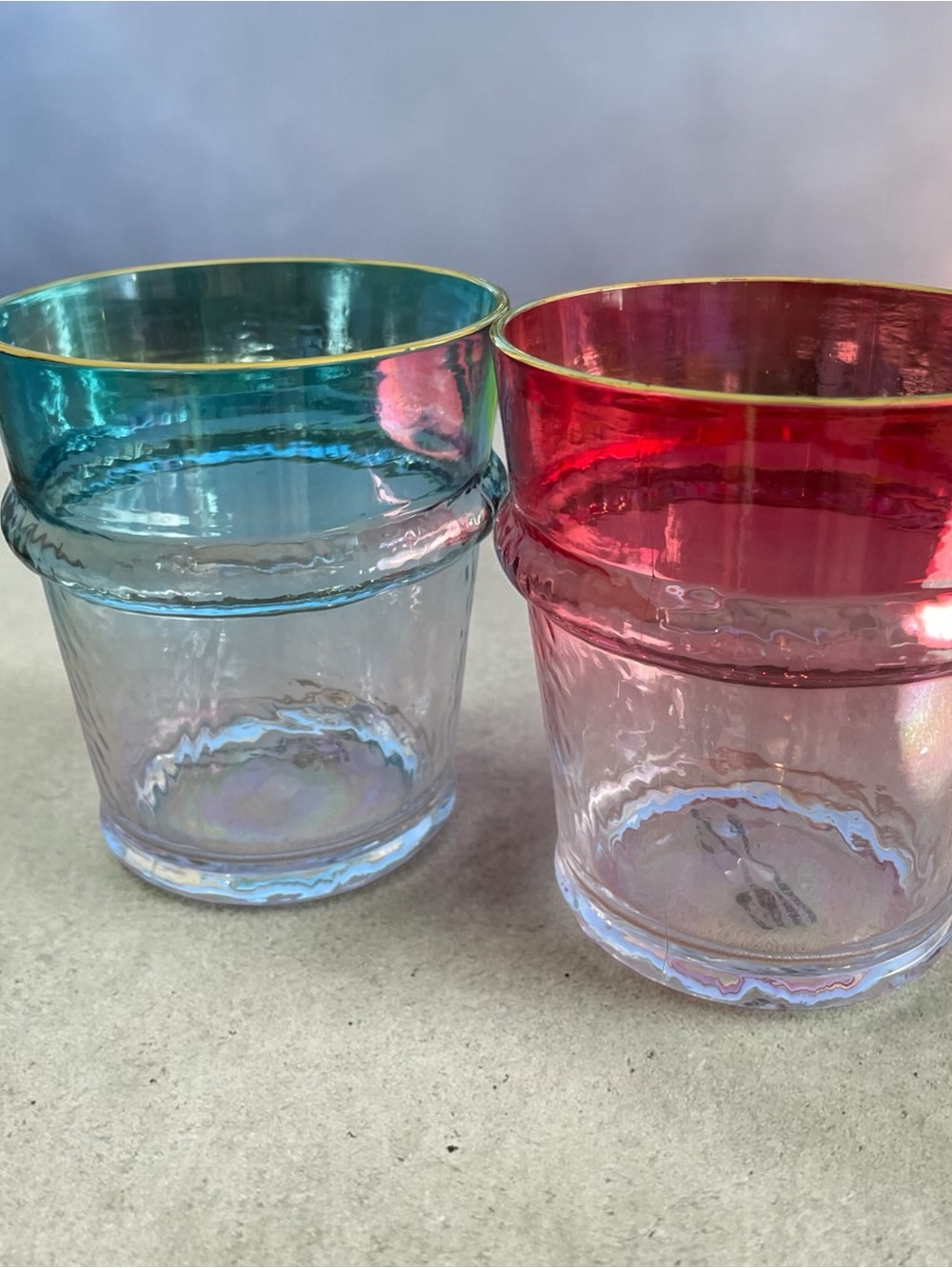 Two elegant plastic glasses for summer drinks, gold rims, stackable